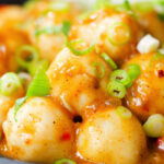 Close-up Hong Kong fish ball curry with rice and spring onions.