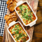 Overhead individual Baked gnocchi alla sorrentina in a tomato and mozzarella sauce.