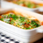 Close-up individual Baked gnocchi alla sorrentina in a tomato and mozzarella sauce.
