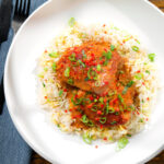 Overhead baked Thai red curry chicken thighs served with egg fried rice.