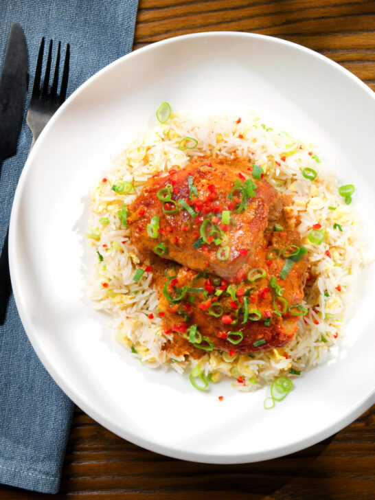 Overhead baked Thai red curry chicken thighs served with egg fried rice.