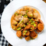 Overhead creamy beef meatball stroganoff served with crispy fried potatoes.