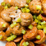 Overhead close-up creamy beef meatball stroganoff served with crispy fried potatoes.