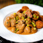 Creamy beef meatball stroganoff served with crispy fried potatoes.