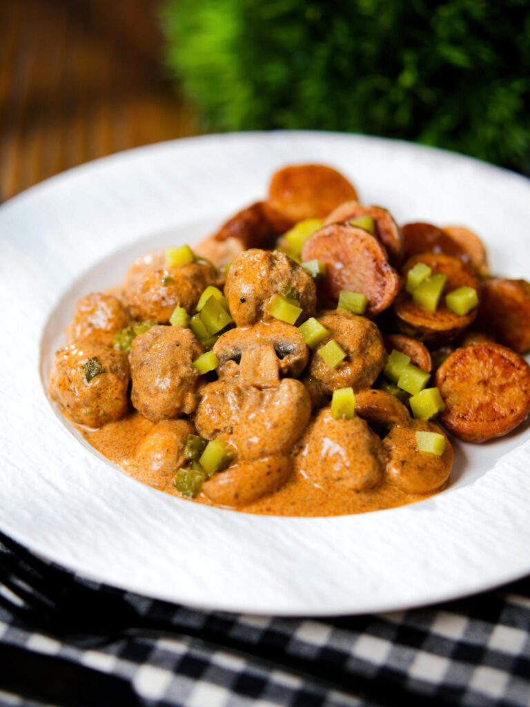 Creamy beef meatball stroganoff served with crispy fried potatoes.