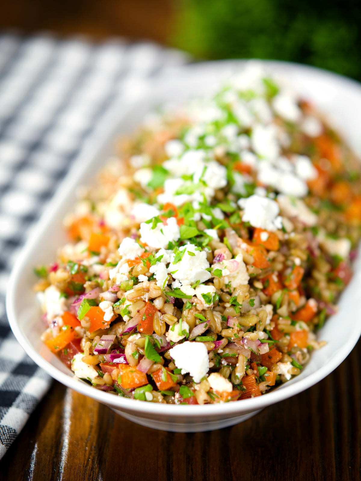 Warm freekeh salad with feta cheese, peppers, tomatoes and parsley.