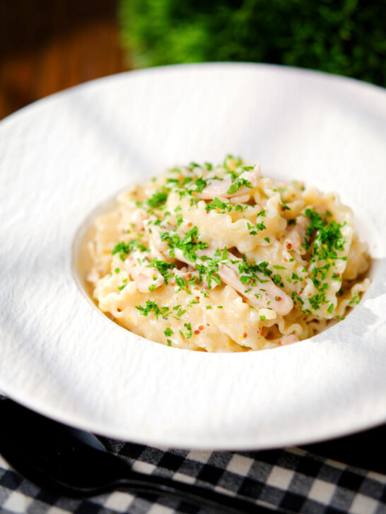 Honey and mustard chicken pasta (malfadine) with chopped parsley.