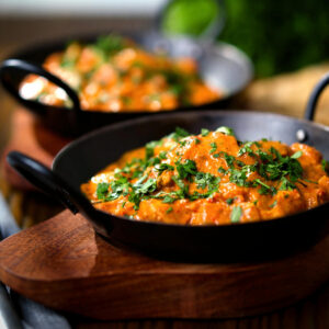 Creamy Kashmiri-style chicken curry served in a kadai with coriander.