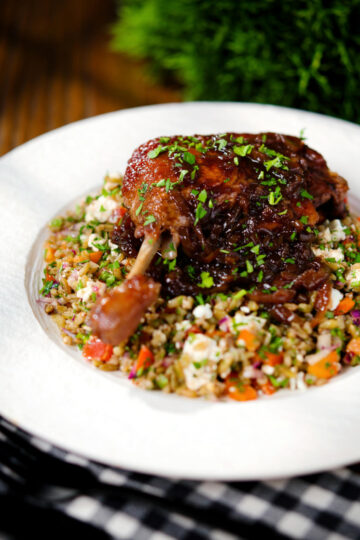 Baked pomegranate molasses duck leg with onions, served with a feta freekeh salad.