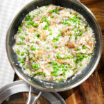 Smoked mackerel risotto with peas, dill and chilli, serve in a cooking pan.