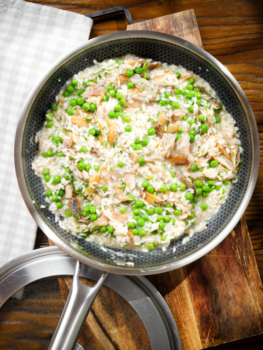 Smoked mackerel risotto with peas, dill and chilli, serve in a cooking pan.