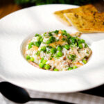 Smoked mackerel risotto with peas and dill served with garlic bread.