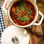 Spezzatino di manzo an Italian beef, red wine and tomato stew in a cooking pot.