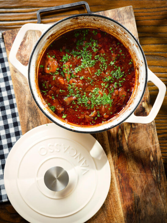 Spezzatino di manzo an Italian beef, red wine and tomato stew in a cooking pot.