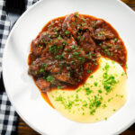 Overhead Spezzatino di manzo an Italian beef, wine and tomato stew served with polenta.