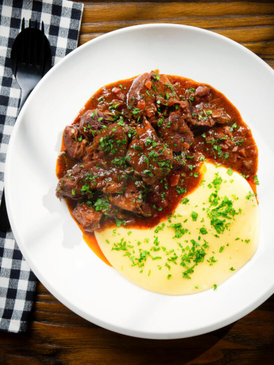 Overhead Spezzatino di manzo an Italian beef, wine and tomato stew served with polenta.