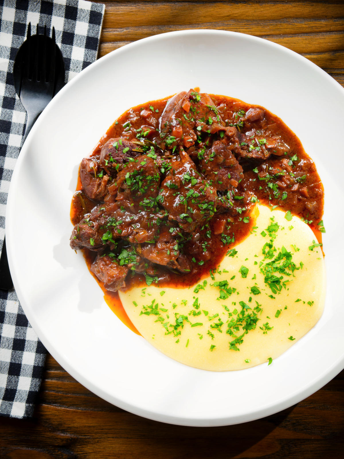Overhead Spezzatino di manzo an Italian beef, wine and tomato stew served with polenta.