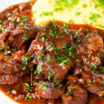 Close-up Spezzatino di manzo an Italian beef, wine and tomato stew served with polenta.