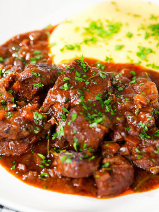 Close-up Spezzatino di manzo an Italian beef, wine and tomato stew served with polenta.