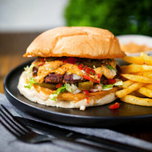 Spicy Mexican beef burger with salsa fresca, chipotle mayonnaise and french fries.