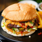 Mexican beef burger with salsa fresca, chipotle mayonnaise served with French fries.