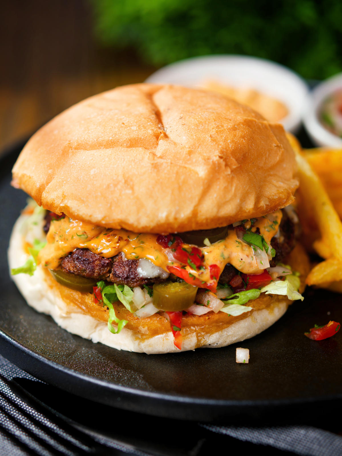 Mexican beef burger with salsa fresca, chipotle mayonnaise served with French fries.