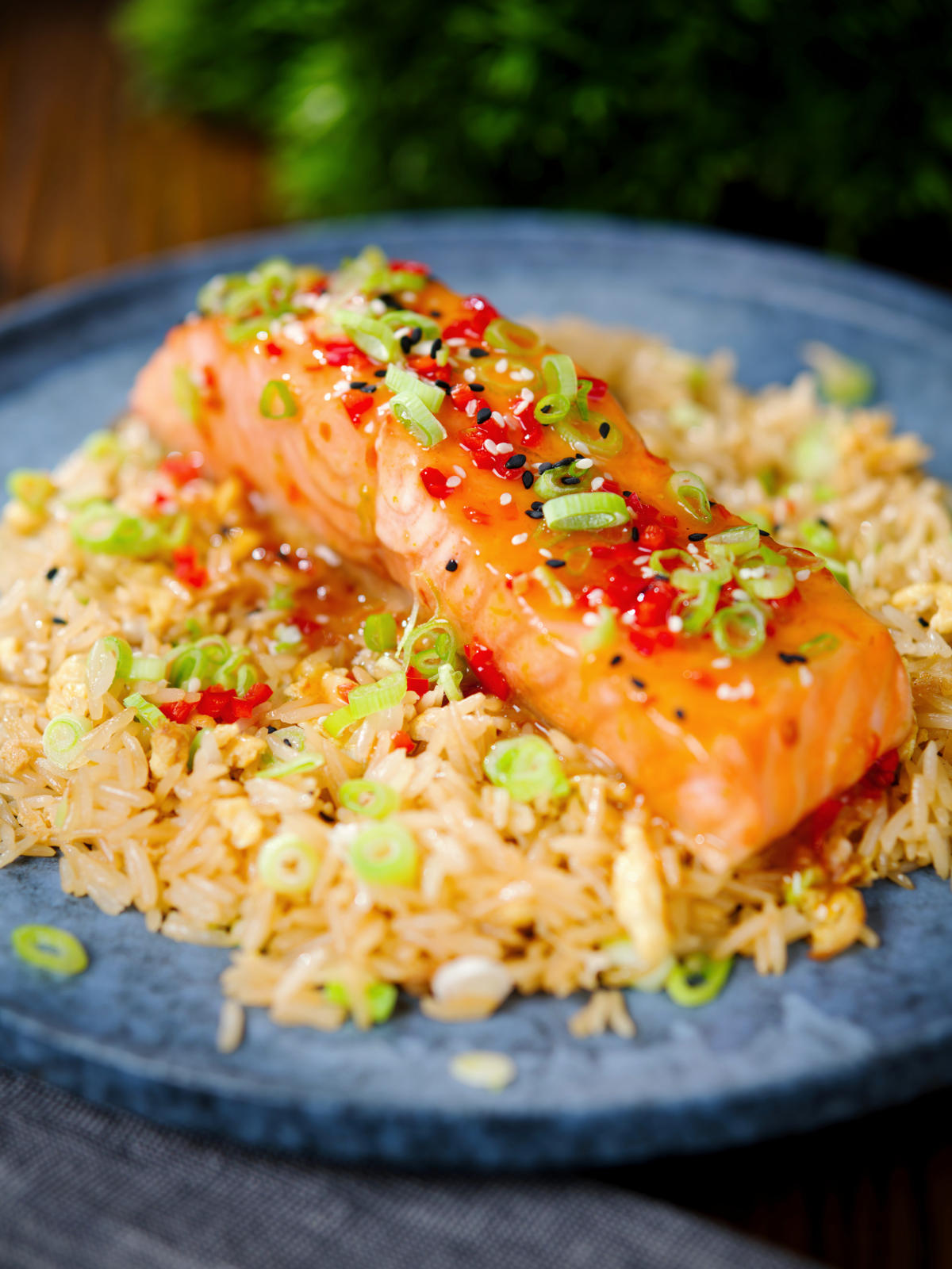Sweet chilli sauce baked salmon with egg fried rice, fresh chilli and spring onions.
