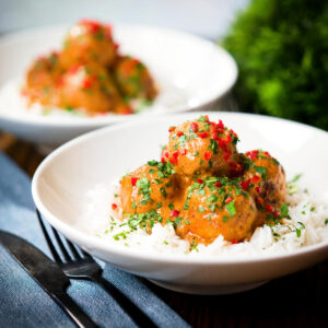 Thai red curry chicken meatballs served with white rice, coriander and fresh chilli.