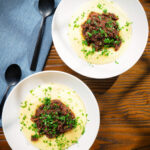 Overhead vegan mushroom ragu sauce served with creamy polenta.