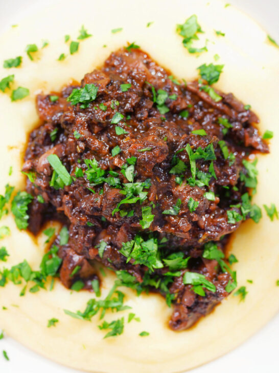 Overhead close-up vegan mushroom ragu sauce served with creamy polenta.