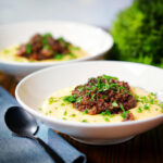 Vegan mushroom ragu served with creamy polenta and fresh parsley.