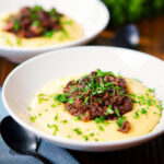 Vegan mushroom ragu sauce served with creamy polenta.