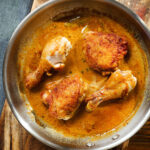 Overhead Filipino chicken adobo (Adobong Manok sa Gata) served in its cooking pan.