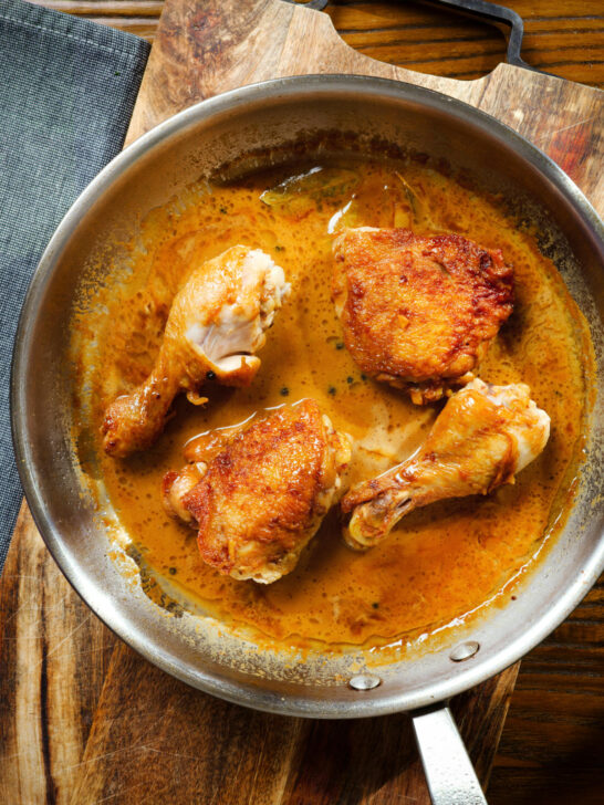 Overhead Filipino chicken adobo (Adobong Manok sa Gata) served in its cooking pan.
