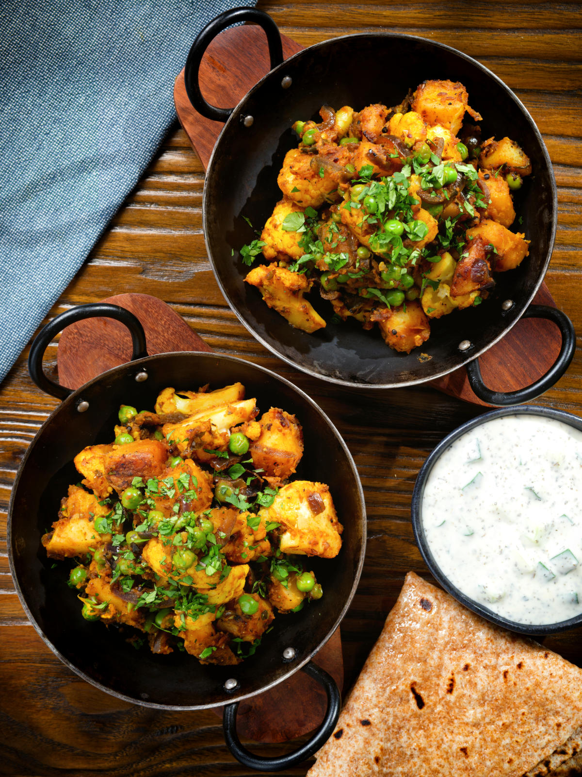 Overhead Indian aloo gobi matar ki sabzi: Dry vegan potato, cauliflower and pea curry.