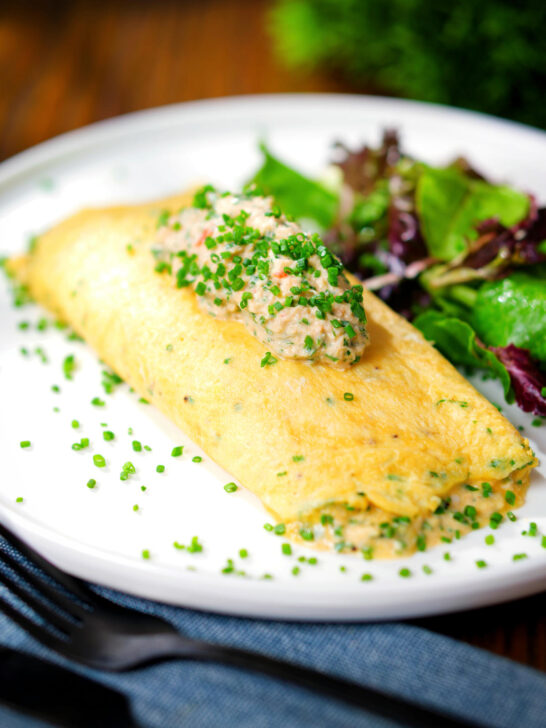 Crab meat and creme fraiche stuffed omelette served with a side salad.