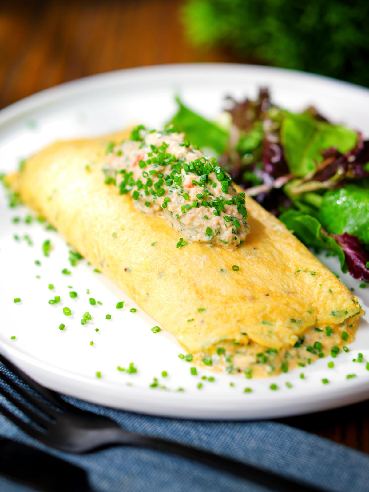 Crab meat and creme fraiche stuffed omelette served with a side salad.