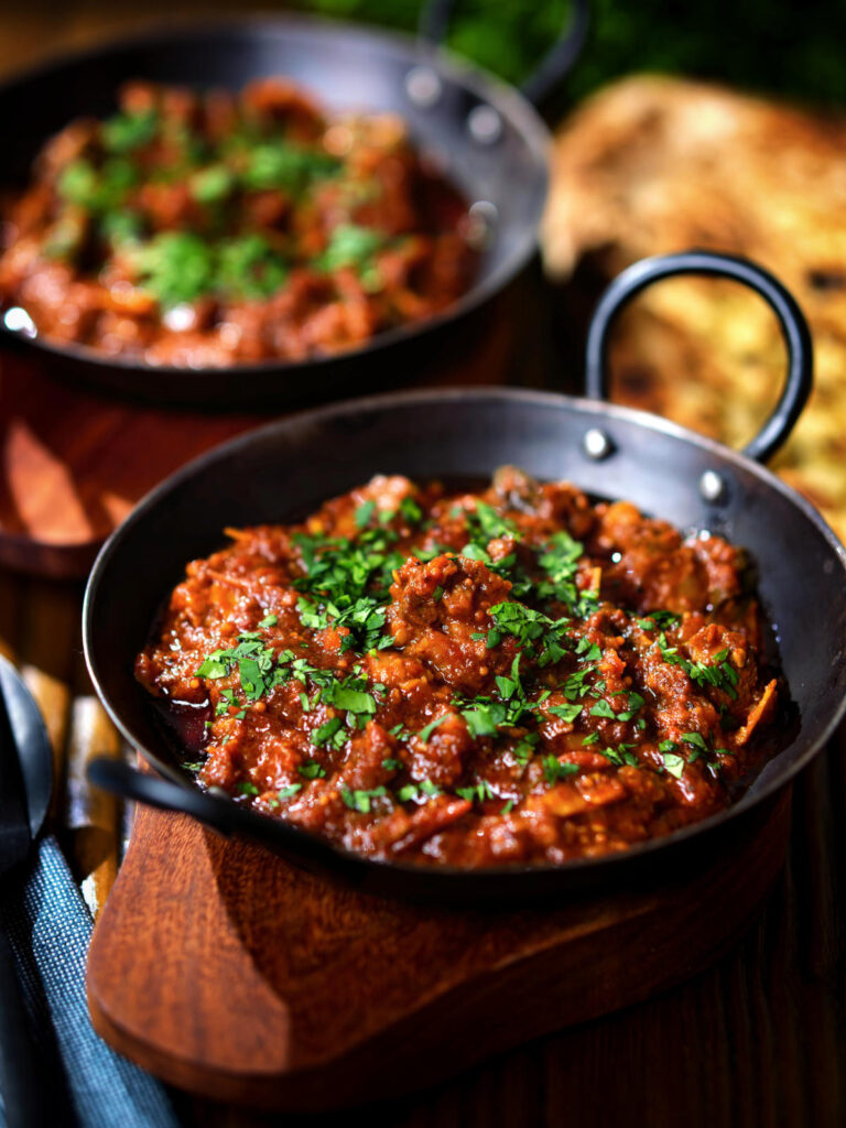 Keralan style beef curry served with fresh coriander and naan bread.
