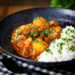 South African influenced lamb and potato Durban curry served with rice and coriander.