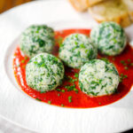 Italian Malfatti (spinach and ricotta dumplings) with tomato sauce, chives and garlic bread.