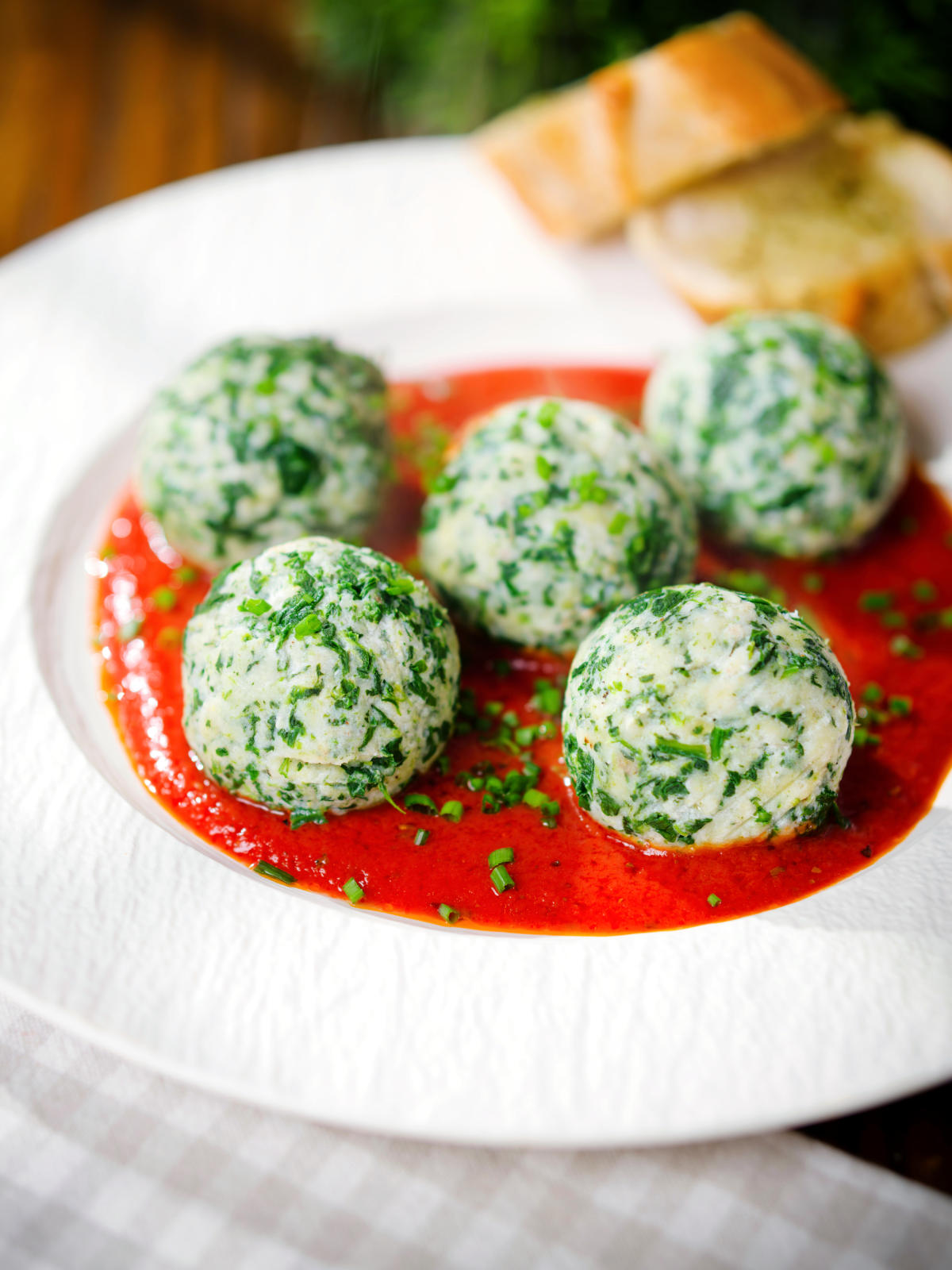 Italian Malfatti (spinach and ricotta dumplings) with tomato sauce, chives and garlic bread.
