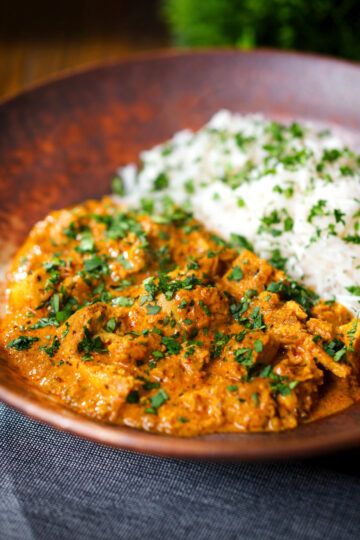 Indian nawabi chicken curry with basmati rice and coriander.