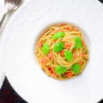 Overhead Sicilian pesto alla trapanese served with spaghetti.