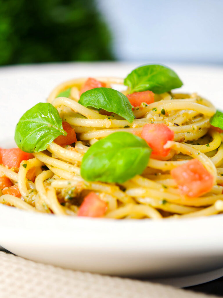 Close-up Sicilian pesto alla trapanese served with spaghetti.