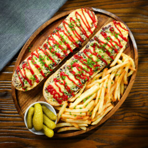 Polish cheese and mushroom zapiekanka open faced sandwich served with ketchup and French fries.