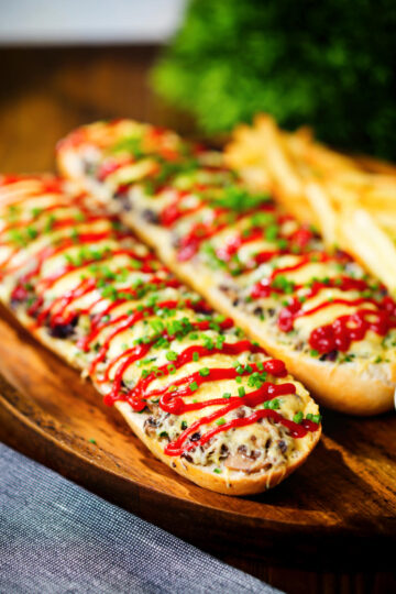 Polish cheese and mushroom zapiekanka open sandwich served with ketchup and fries.