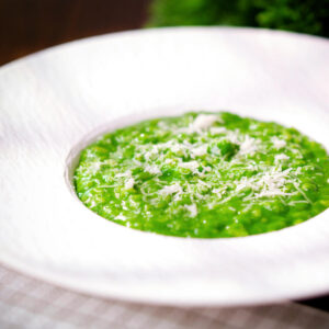 Risotto verde with spinach, green peas and broad beans topped with grated Parmesan cheese.