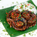 Vegan mushroom rendang curry served with rice, fresh chilli and coriander.