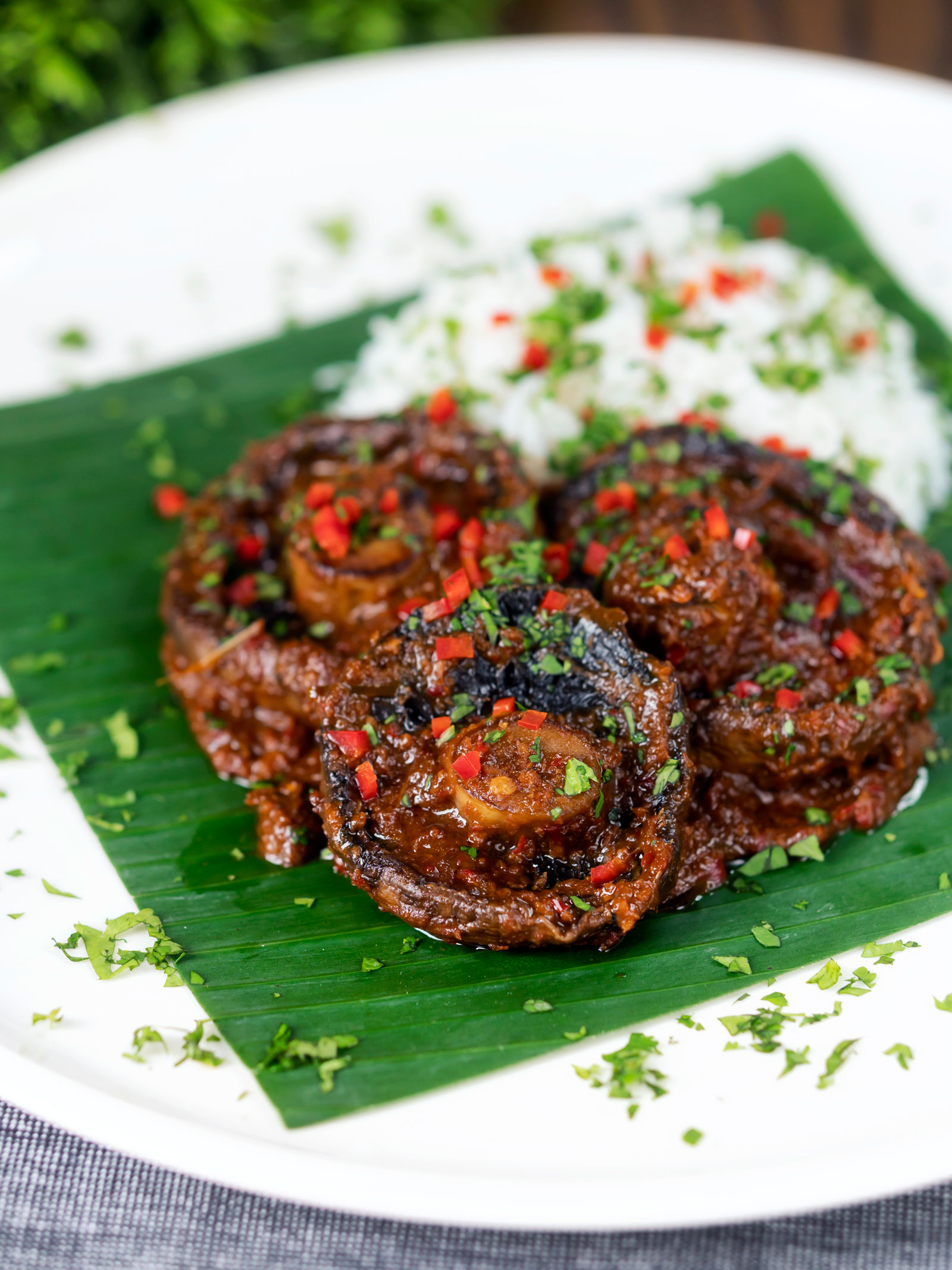 Vegan mushroom rendang curry served with rice, fresh chilli and coriander.