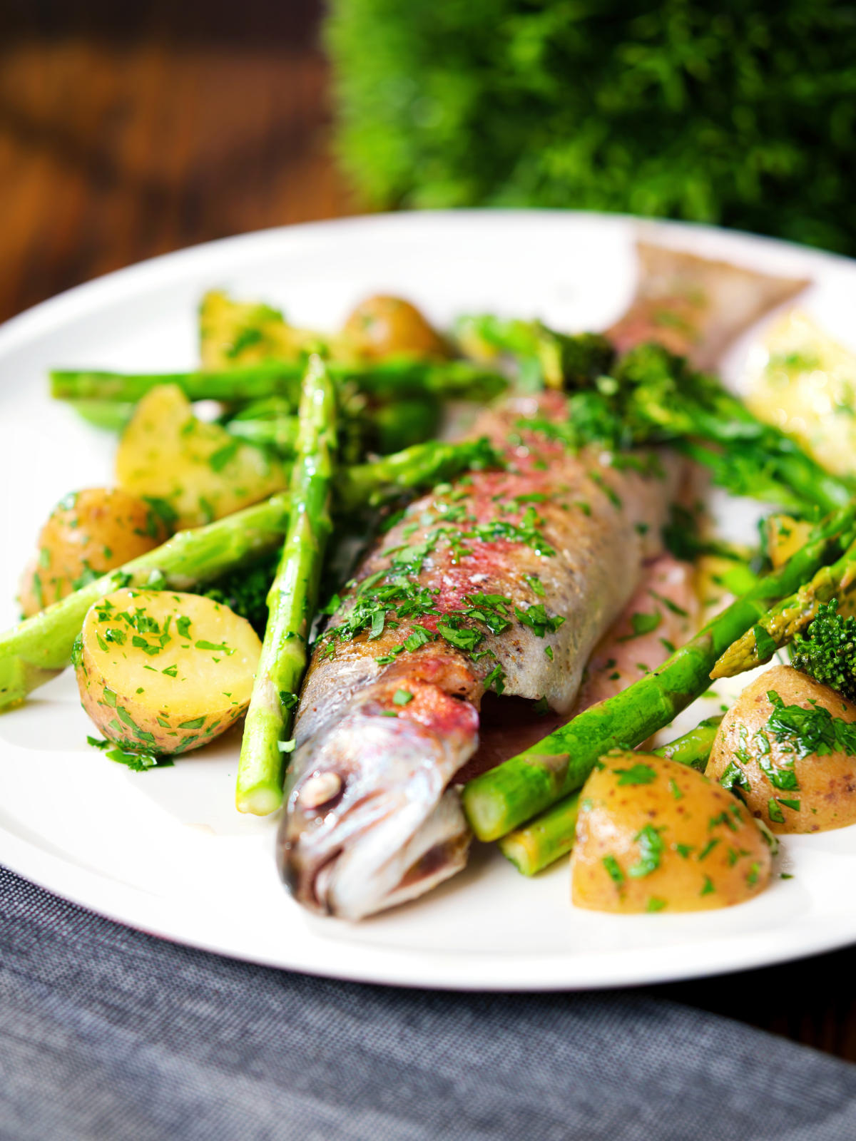 Baked fish (rainbow trout) that was cooked in foil with asparagus and tenderstem broccoli, served with buttered potatoes.